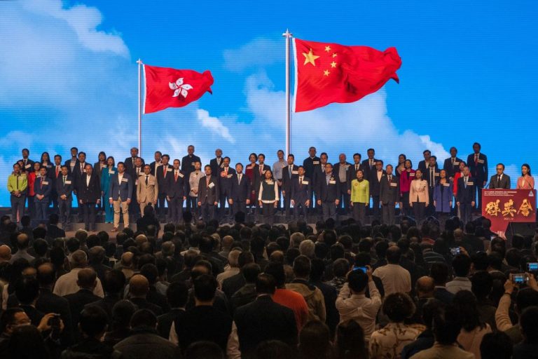 Legislative Council candidates sing communist China's national anthem at the 2021 Legislative Council General Election Committee Constituency Candidate Forum ahead of the December 19 election at the Hong Kong Convention and Exhibition Centre on December 17, 2021.