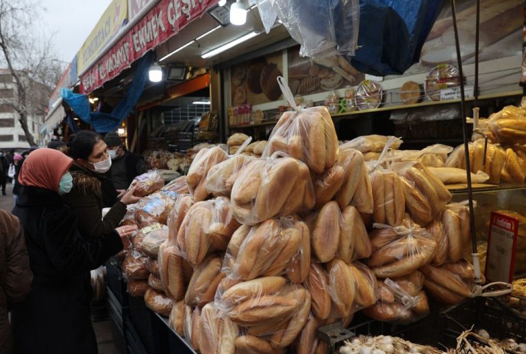 Women shop for bread at a market in Ankara on December 20, 2021 as Turkey's troubled lira took a nosedive after Turkish President cited Muslim teachings to justify not raising interest rates to stabilise the currency.