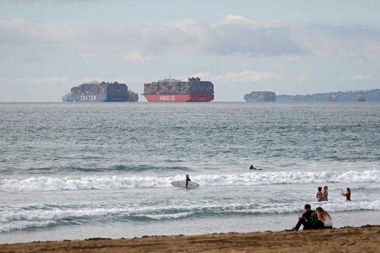 Cargo ships sit off the coast of Huntington Beach, California on October 23, 2021. More than 100 ships are waiting to unload containers outside the ports of Los Angeles and Long Beach.