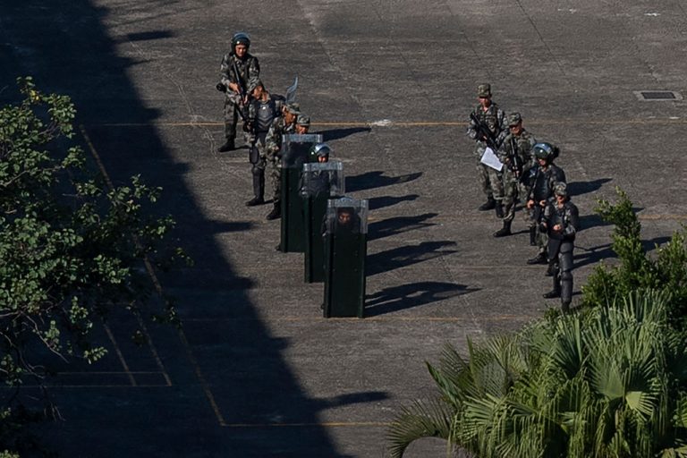 Chinese People's Liberation Army (PLA) soldiers train inside the PLA Hong Kong Garrison barracks, seen from the Hong Kong Polytechnic University where dozens of pro-democracy protesters remain holed up inside on November 21, 2019. A garrison of thousands of PLA troops has long been stationed in Hong Kong since the handover from British to Chinese rule in 1997.