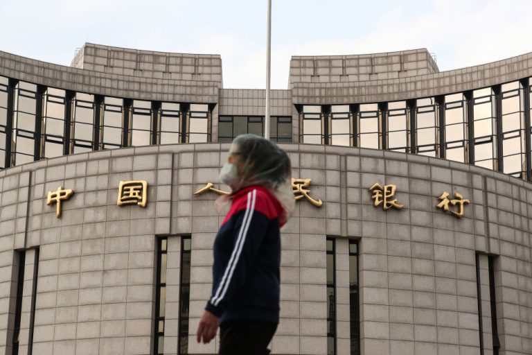 A woman wears a protective mask as she walks past the People's Bank Of China (PBOC) on Financial Street, April 17, 2020 in Beijing, China. China's gross domestic product (GDP) stood at 20.65 trillion yuan (about 2.91 trillion U.S. dollars) in the first quarter of 2020 amid COVID-19 impact, down 6.8 percent year on year, according to data from the National Bureau of Statistics (NBS).
