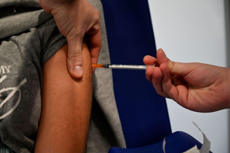 A child receives a dose of the Pfizer-BioNTech (Comirnaty) Covid-19 vaccine at the Principe de Asturias de Alcala hospital en Madrid, on December 15, 2021, on the first day of Spain's immunisation campaign for five to 11-year-olds.
