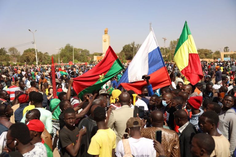 Demonstrators gather in Ouagadougou to show support to the military while holding and waiving a Russian flag on Jan. 25. In the aftermath of the coup d'etat in Burkina Faso which overthrew President Roch Marc Christian Kaboré, a demonstration in support of the putschists is scheduled for Tuesday in Ouagadougou where calm has returned after days of tension.
