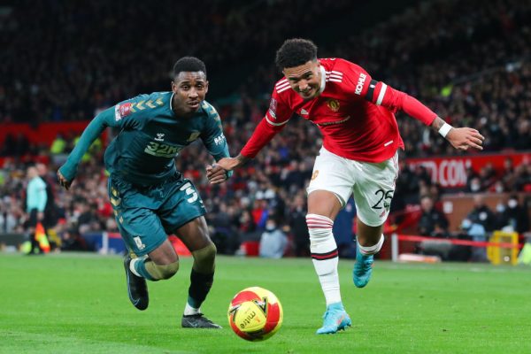 Anfernee Dijksteel of Middlesbrough battles for possession with Jadon Sancho of Manchester United during the Emirates FA Cup Fourth Round match between Manchester United and Middlesbrough