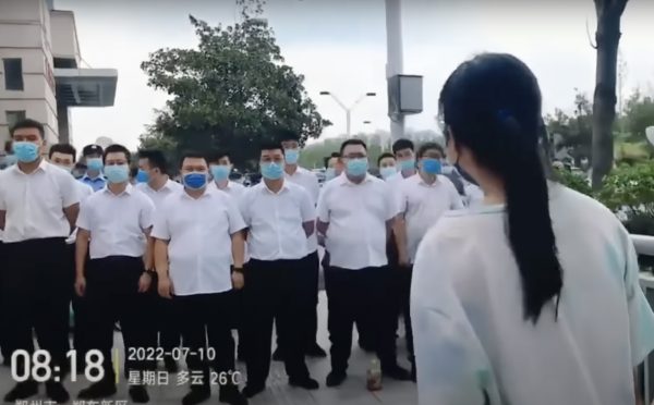 woman_plainclothes-police_zhengzhou-henan-china-20220710_protests_bank.jpg