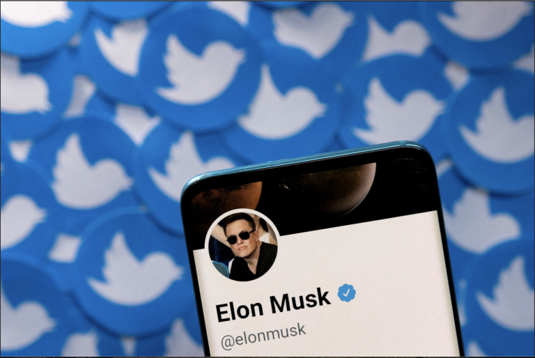 Elon Musk's Twitter profile is seen on a smartphone placed on printed Twitter logos in this picture illustration taken April 28, 2022. (Image: Screenshot / Reuters)