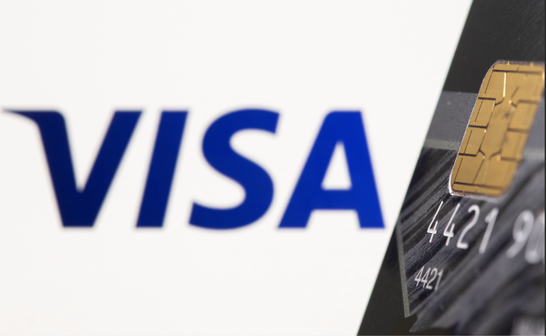 Credit card is seen in front of displayed Visa logo in this illustration taken, July 15, 2021. (Image: Screenshot / Reuters)