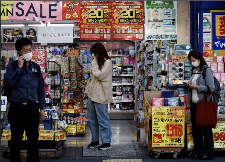 A woman chooses products at a drug store in Tokyo, Japan October 21, 2022. (Image: Screenshot / Reuters)