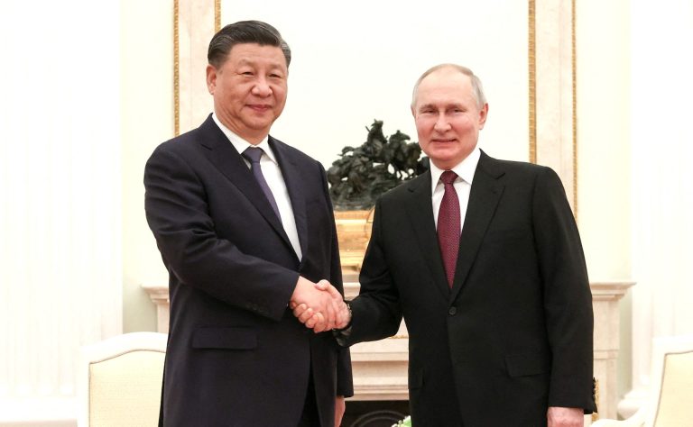 Russian-President-Vladimir-Putin-Chinese-President-Xi-Jinping-shake-hands-meeting-Kremlin-Moscow-Russia-March-20.