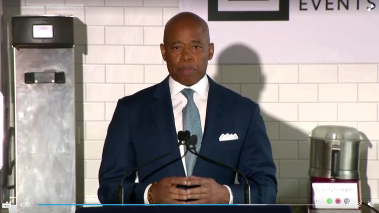 new-york-city-mayor-eric-adams-addresses-the-convened-press-at-the-industry-city-warehouse-complex-in-brooklyn-about-the-housing-problems-for-migrants