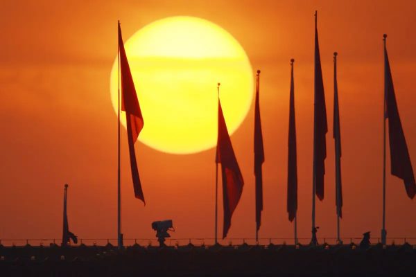 flags of communist china before a sunset in beijing tiananmen square forbidden city