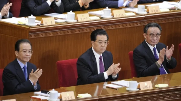 Wen Jiabao seated with senior Chinese leaders at a formal political meeting.