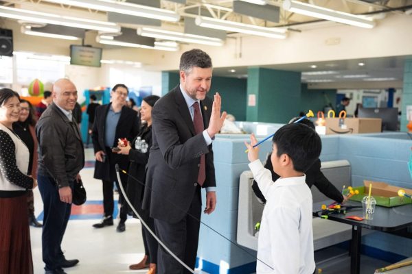 U.S. Rep. Patrick Ryan shares a high five with a young attendee during a Chinese New Year celebration hosted by the Middletown Chinese community in Middletown, New York.