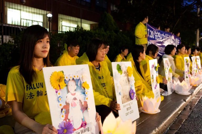 Falun Gong adherents attend a candlelight vigil in front of the Chinese Consulate in Toronto, 2021
